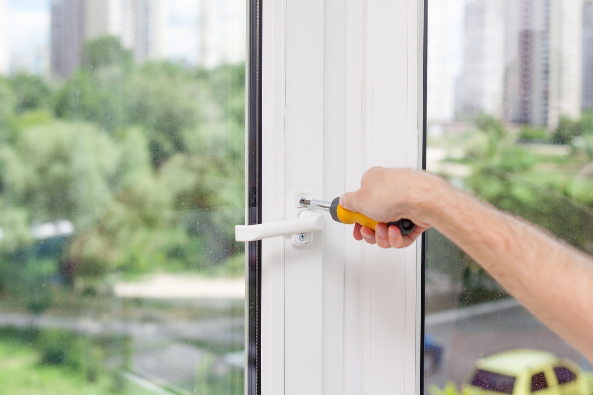 Trabalhador manual reparos janela plástica com chave de fenda